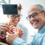 Expert care by a north Edmonton orthodontist assisting a patient adjustments with braces.